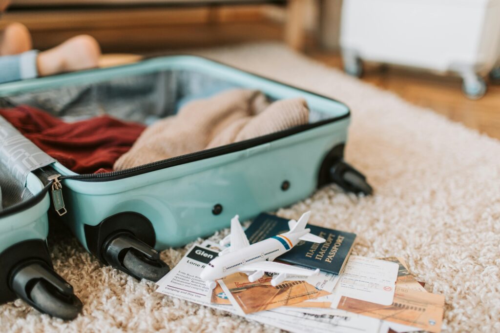 Open suitcase with travel essentials, passport, and boarding passes laid out—perfect for solo travel to Colombia.