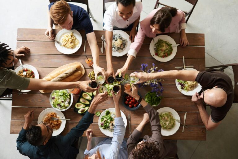 Group of Colombian friends sharing a meal around a dinner table, reflecting warmth, connection, and cultural nuance.